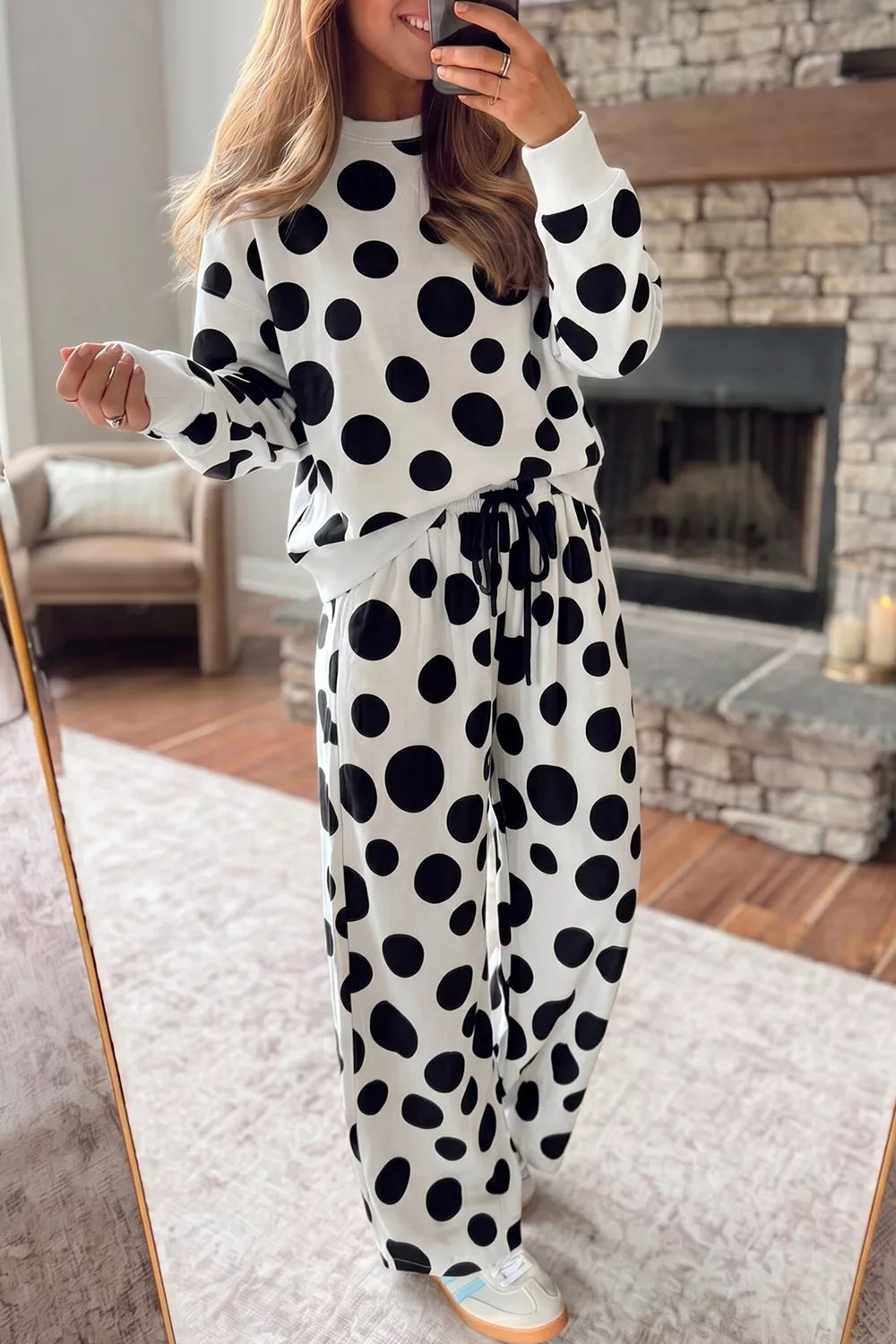 Woman wearing Black and white polka dot two piece wide le pants set 
