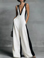 Woman wearing white wide leg sleeveless jumpsuit with deep v neck 